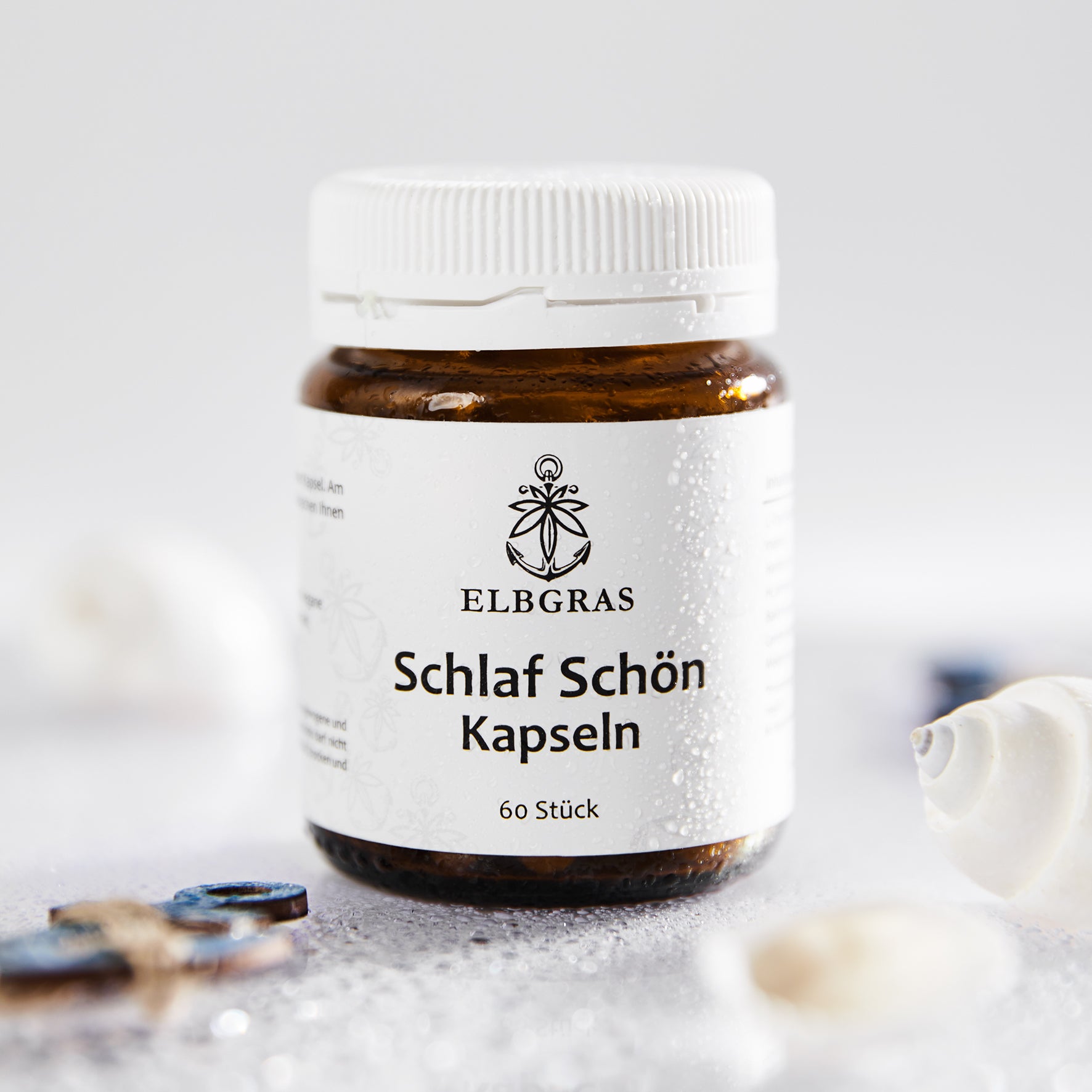 Braune Dose mit weißem Etikett, Aufschrift "Elbgras Schlaf Schön Kapseln", 60 Stück, weißer Schraubverschluss.